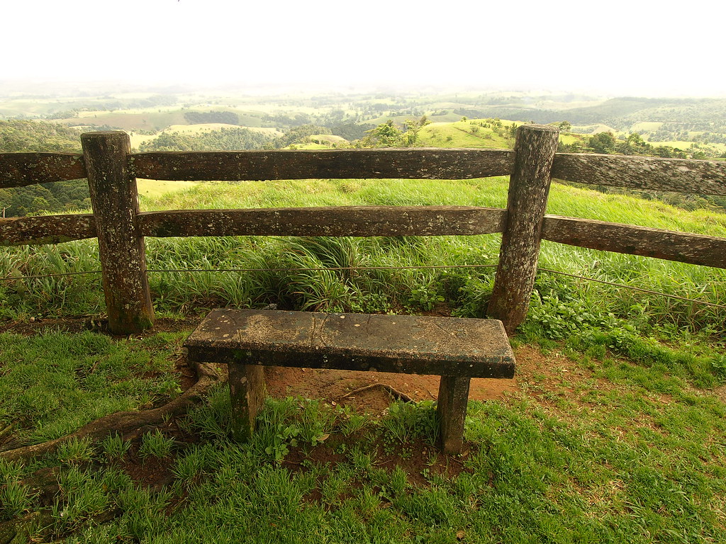 A bench at a lookout over the green Atherton Tablelands, Queensland