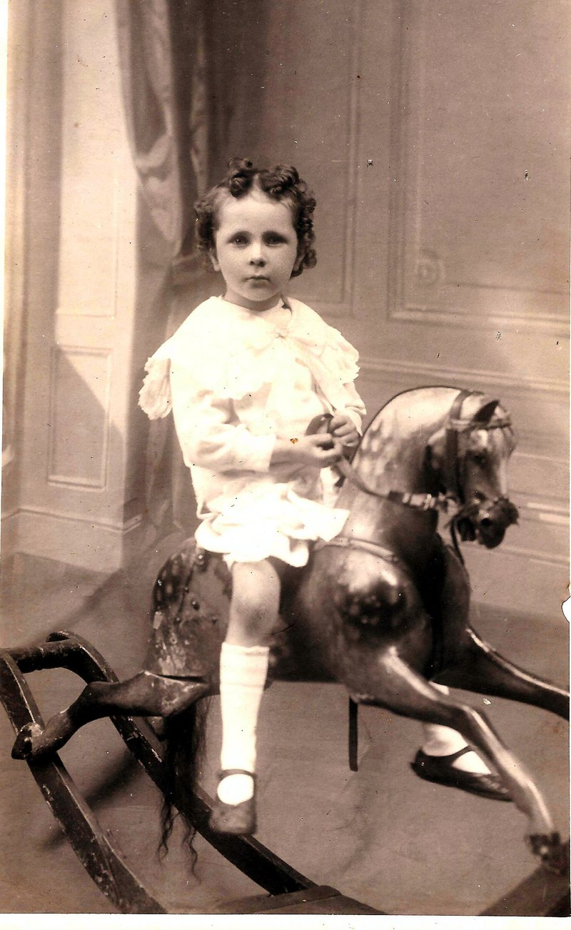 Sepia studio photograph of Alfie Briant as a small boy on a rocking horse