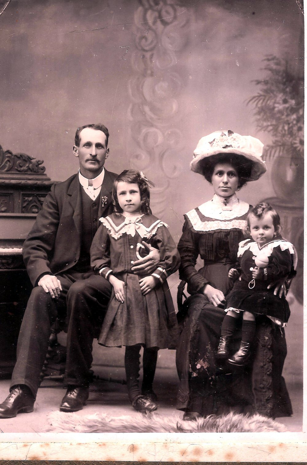 Formal studio portrait of Alf and Clara Briant with their daughter Una and young son Alfie